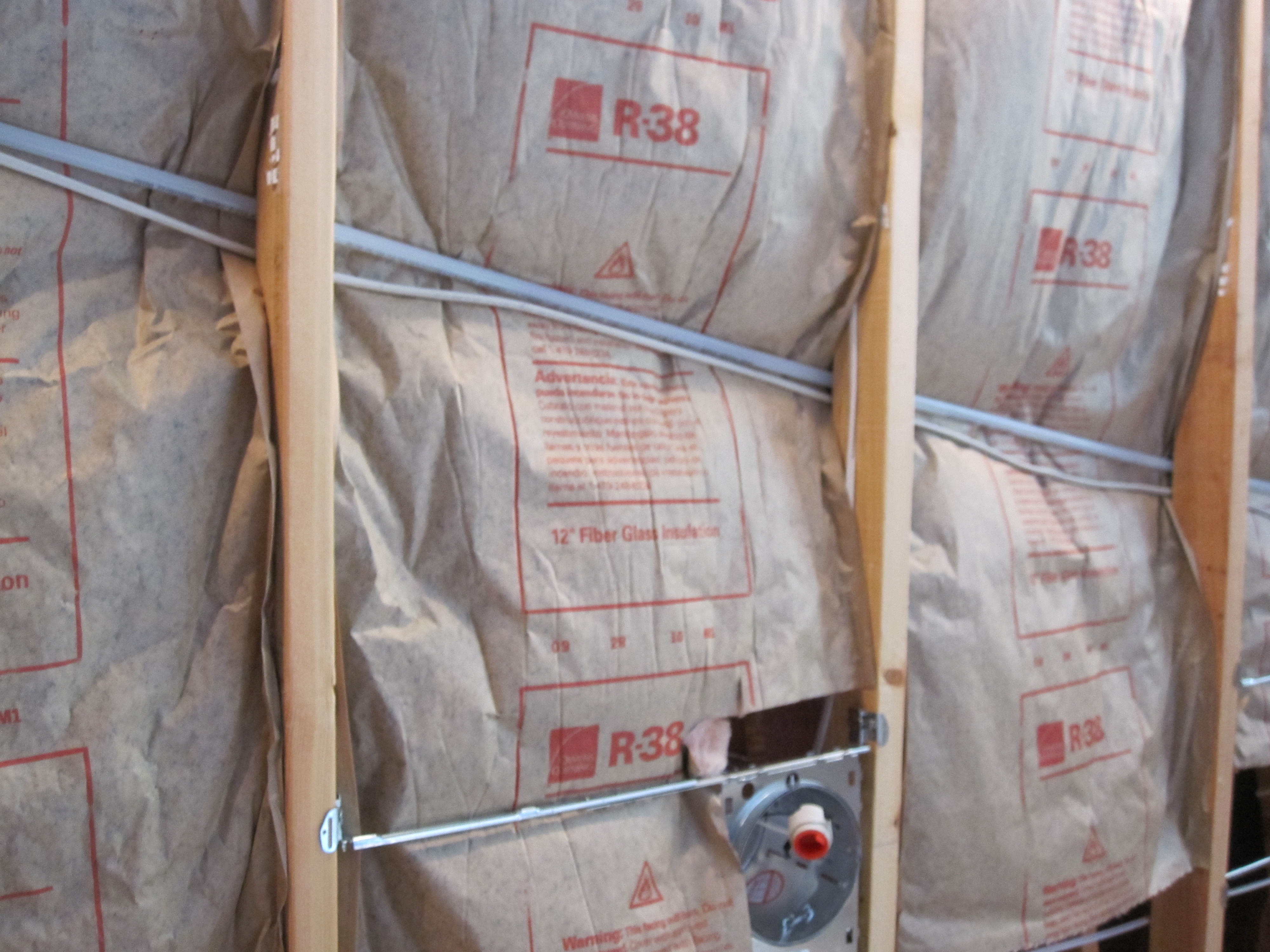 This faced fiberglass batt insulation was incorrectly installed.