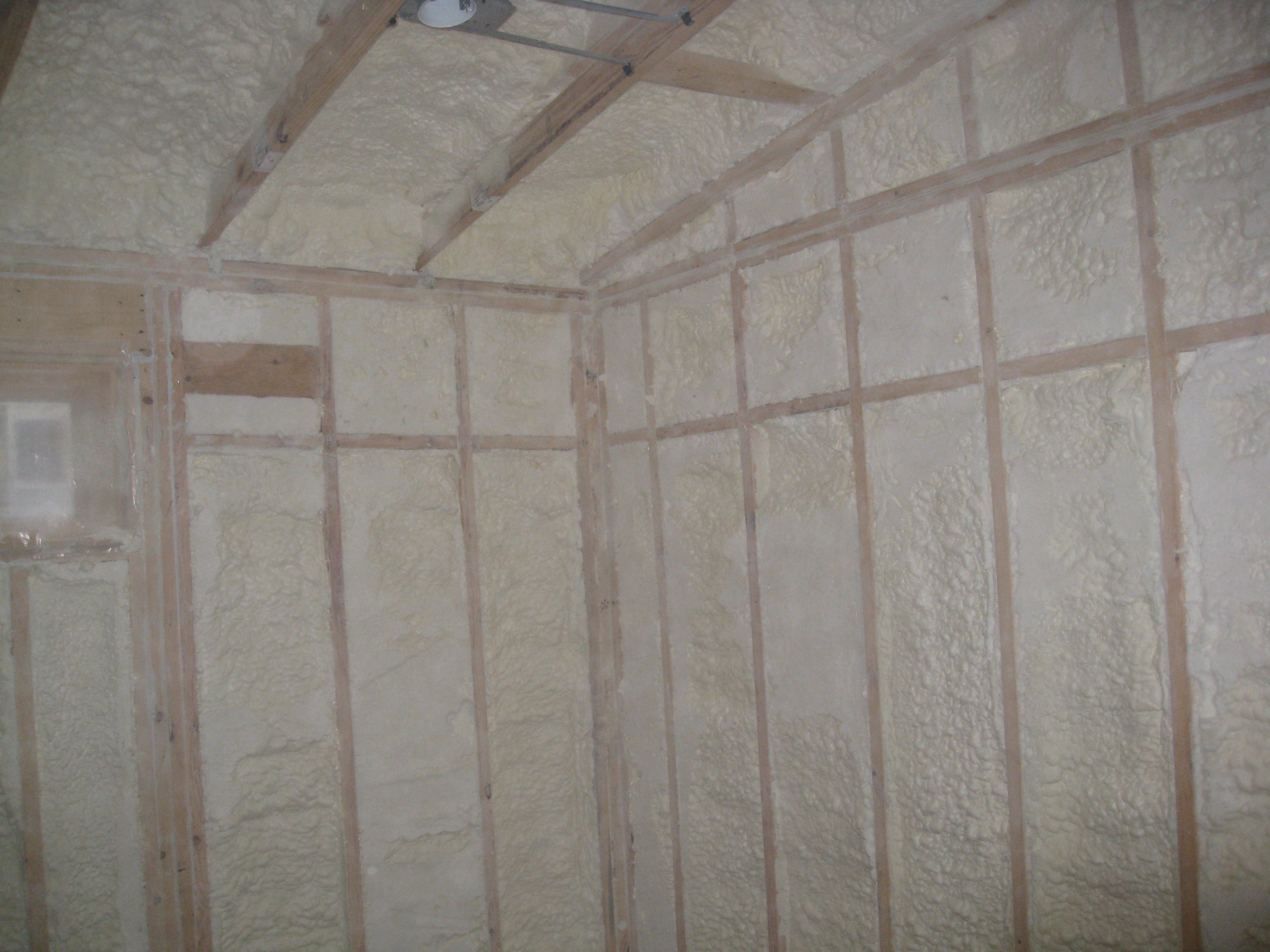 Spray foam insulation is installed in open wall cavities to air seal and insulate.