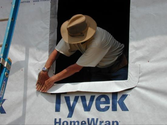 After installing the house wrap over the SIPS, window flashing is installed.
