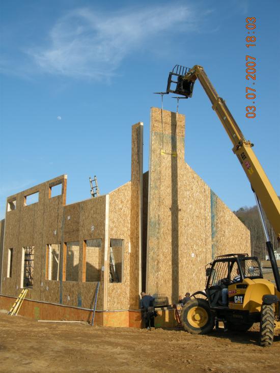 A crane is used to install the SIP fireplace chimney chase.