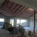 Insulation was added to the walls and ceiling of this existing home from the inside as part of an extensive retrofit to avoid replacing original 1-inch shiplapped sheathing. 