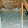 Spray foam insulates and air-seals the ceiling deck and top plates of this vented attic.
