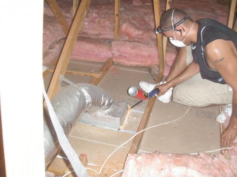 Duct boots and other ceiling penetrations are air-sealed using spray foam